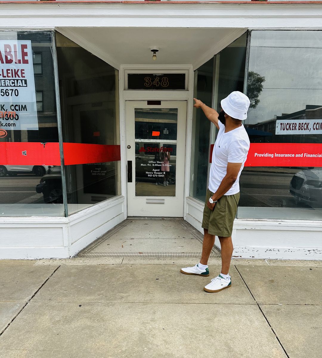 Marlon Thomas, owner of The Cap Bar, pointing to the door at 348 South Main Street in Memphis